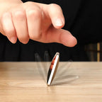 HexFlip fidget spinner in metallic silver performing a spin flip on wooden surface - stress relief desk toy in action