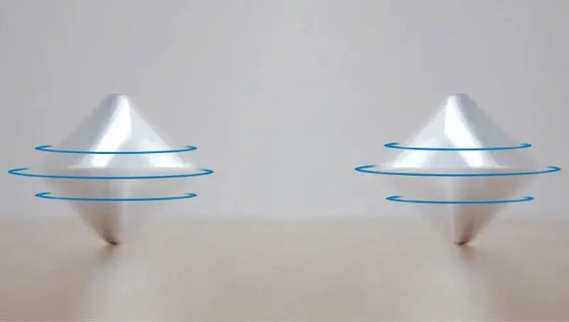 HexFlip fidget toy in silver metal with blue spinning rings demonstrated in flipping motion on beige surface