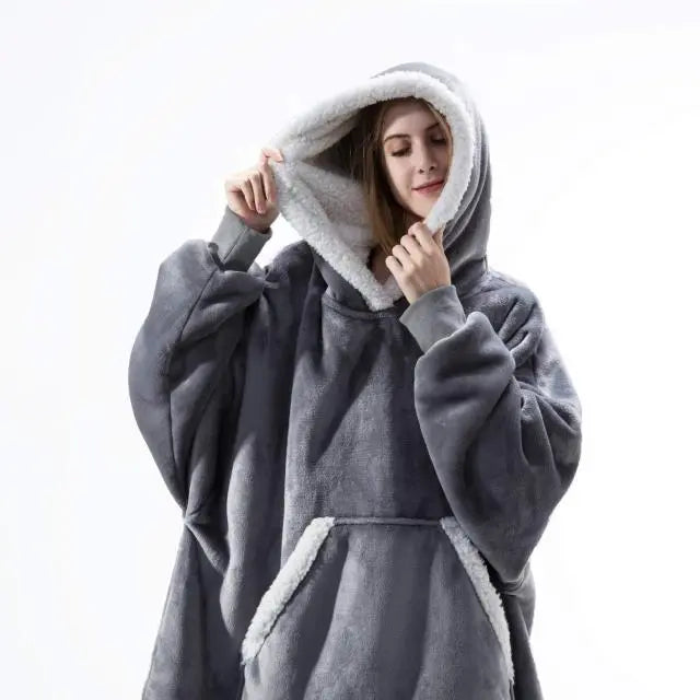 Oversized Hoodie Blanket in gray microfiber with white sherpa lining, showing cozy front pocket and roomy hood design