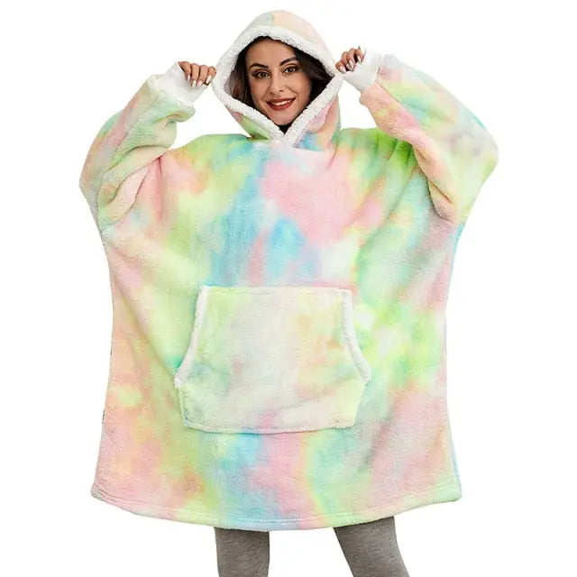 Oversized Hoodie Blanket in pastel tie-dye pattern with sherpa-lined hood and kangaroo pocket, shown on model