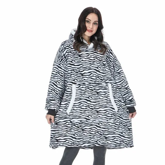 Oversized Hoodie Blanket in zebra print pattern with kangaroo pocket, shown on model displaying cozy comfort wear
